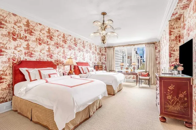a bathroom with a double vanity sink a mirror and a bathtub