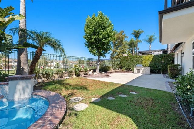a view of a backyard with swimming pool