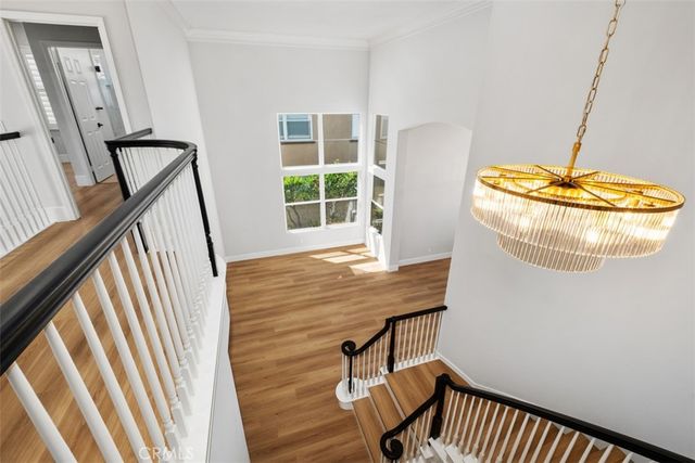 a view of a room with wooden floor and windows