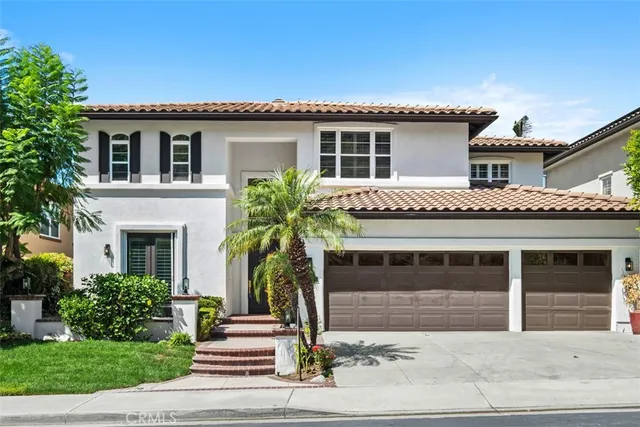 a front view of a house with a garden and plants