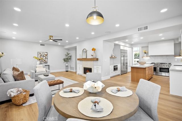 a living room with furniture kitchen table and kitchen view