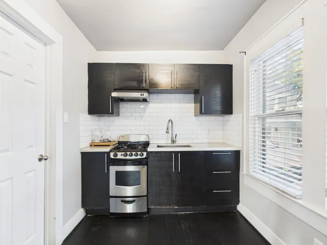 a kitchen with stainless steel appliances a stove and a sink