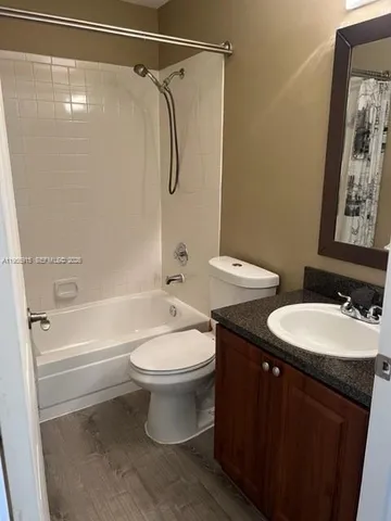 a bathroom with a double vanity sink toilet and shower