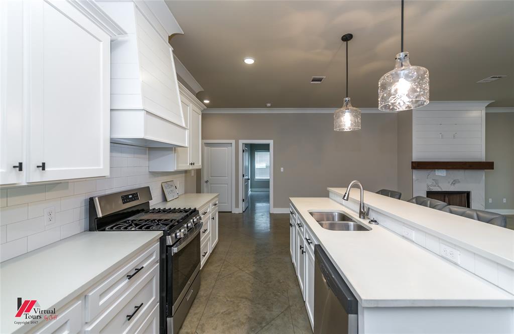 1320 Fuller Cemetery Road Minden, LA 71055 - Photo 21 of 40 Modern kitchen featuring white shaker cabinetry, stainless steel appliances, a gas range, and a subway tile backsplash
