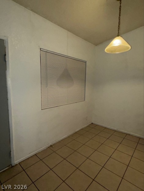 521 North Decatur Boulevard, Unit B Las Vegas, NV 89107 - Photo 15 of 17 A modest dining area features durable tile flooring and a functional light fixture.