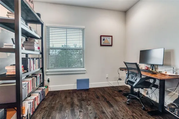 a bedroom with a bed and a desk