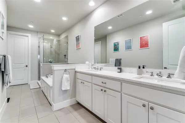 a spacious bathroom with a bathtub and a shower