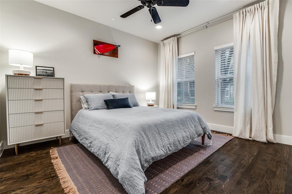 7700 Eastern Avenue, Unit 104 Dallas, TX 75209 - Photo 20 of 25 a bedroom with a large bed and a chandelier