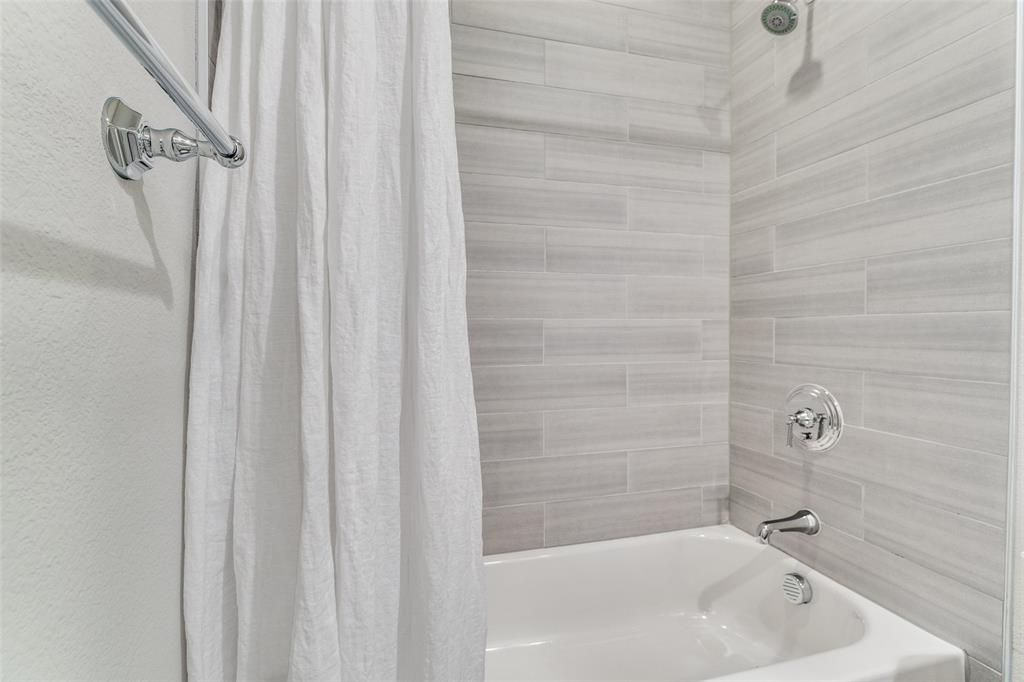 7700 Eastern Avenue, Unit 104 Dallas, TX 75209 - Photo 23 of 25 a bathroom with a sink a bathtub and shower