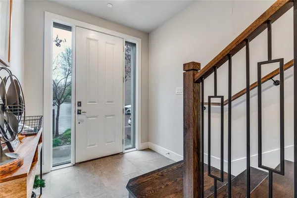 a view of a hallway with wooden floor and stairs