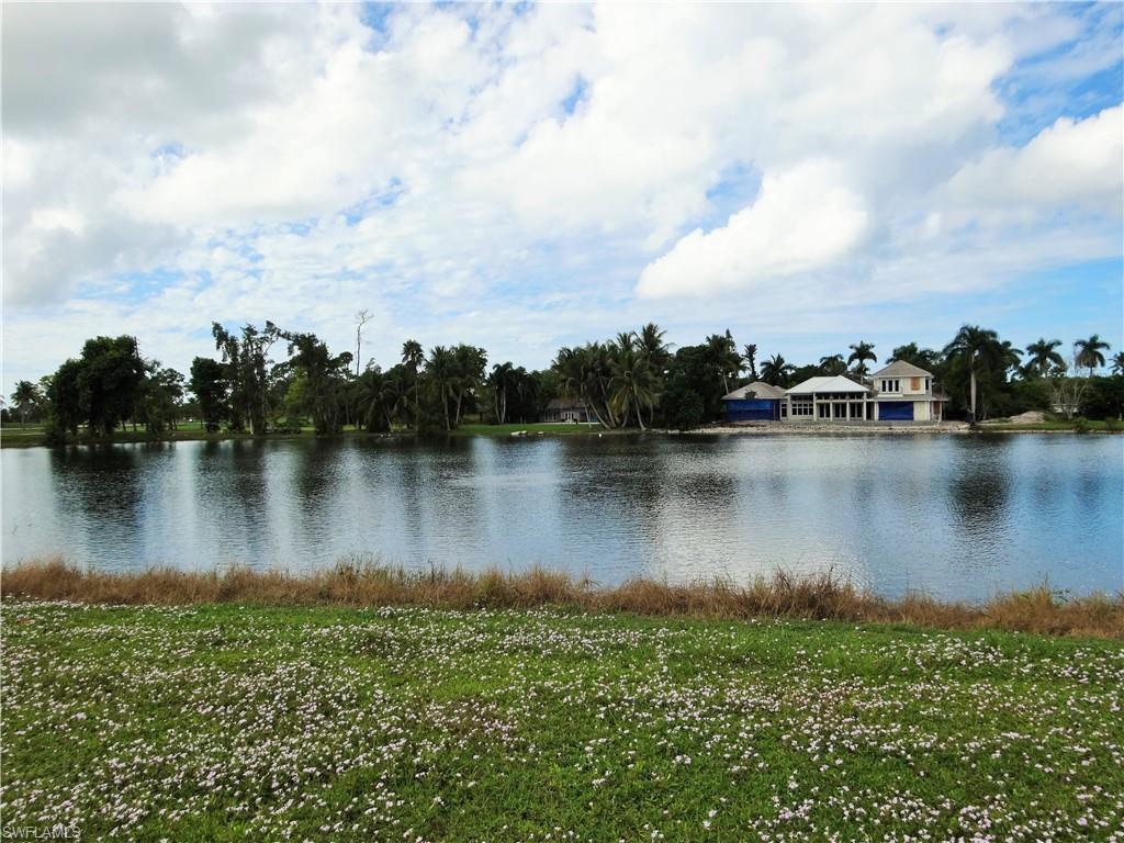 610 Banyan Circle Naples, FL 34102 - Photo 1 of 15 a view of a lake with houses in the back