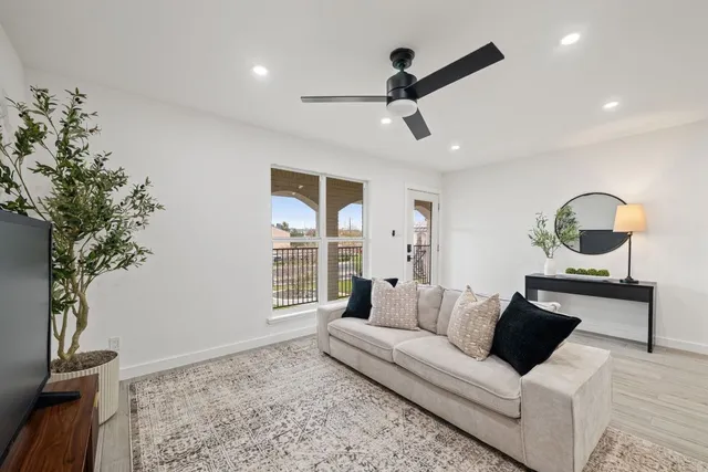 a living room with furniture and a potted plant