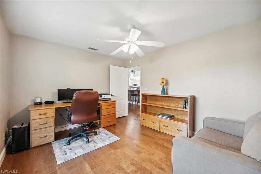 900 Hidden Harbour Drive Naples, FL 34109 - Photo 13 of 32 a workspace with furniture and a chandelier fan