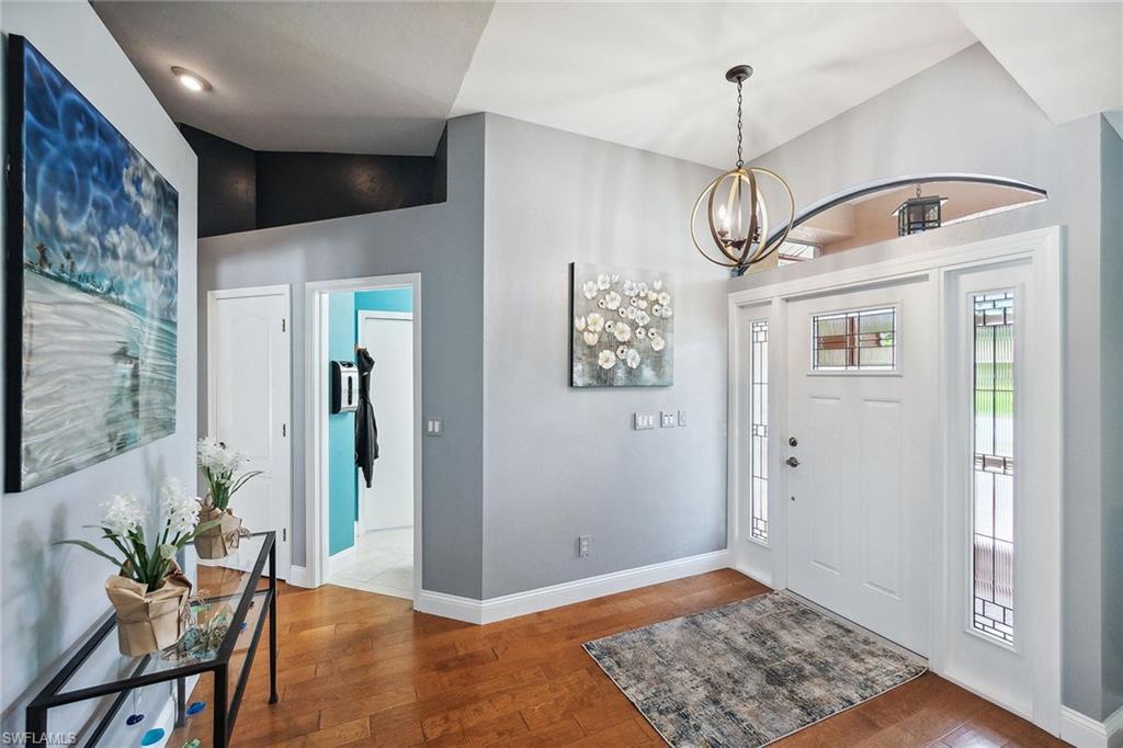 900 Hidden Harbour Drive Naples, FL 34109 - Photo 2 of 32 a view of a hallway with wooden floor and dining space