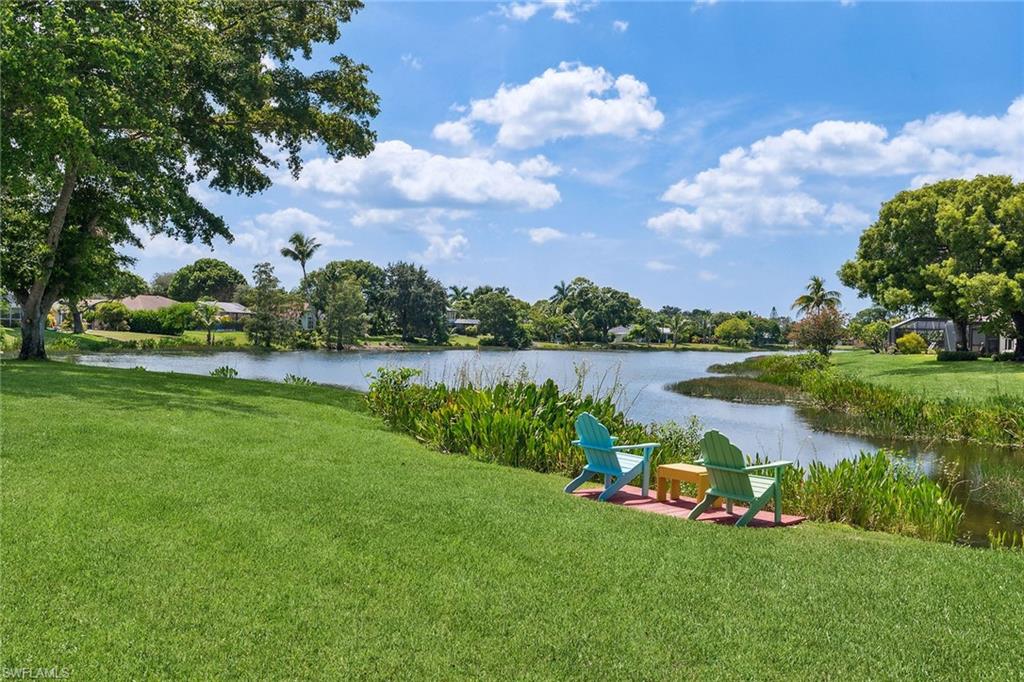 900 Hidden Harbour Drive Naples, FL 34109 - Photo 26 of 32 a view of a lake with houses in the back