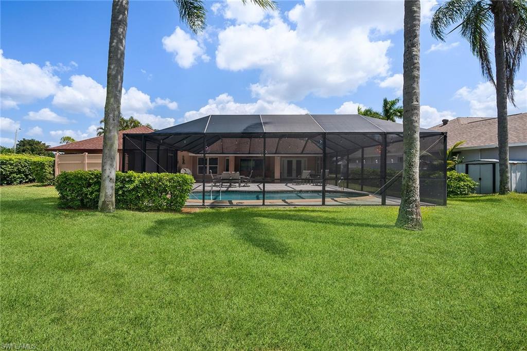 900 Hidden Harbour Drive Naples, FL 34109 - Photo 29 of 32 a view of a patio with a table and chairs under an umbrella