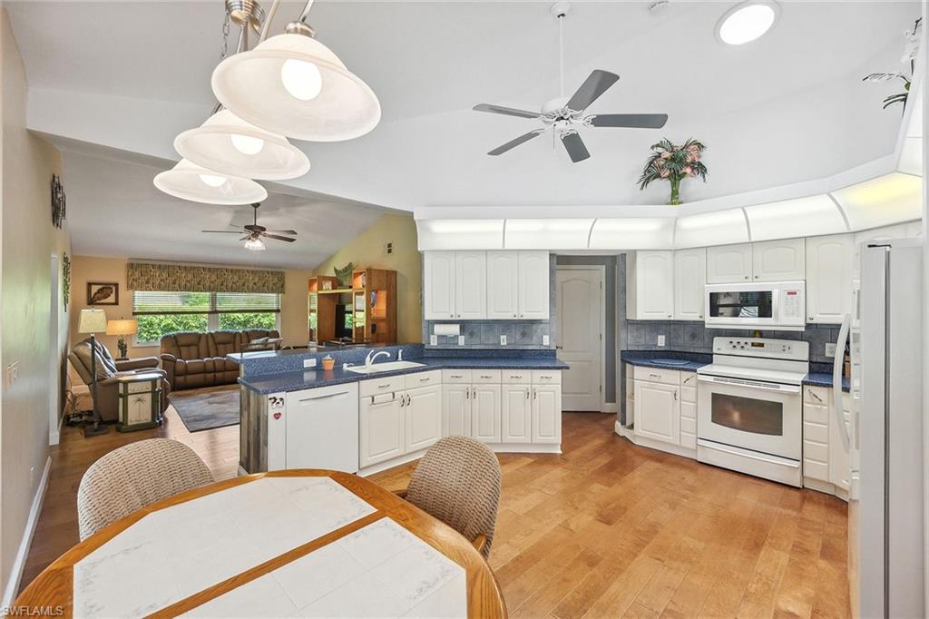 900 Hidden Harbour Drive Naples, FL 34109 - Photo 7 of 32 a kitchen with stainless steel appliances granite countertop a sink a stove and a refrigerator