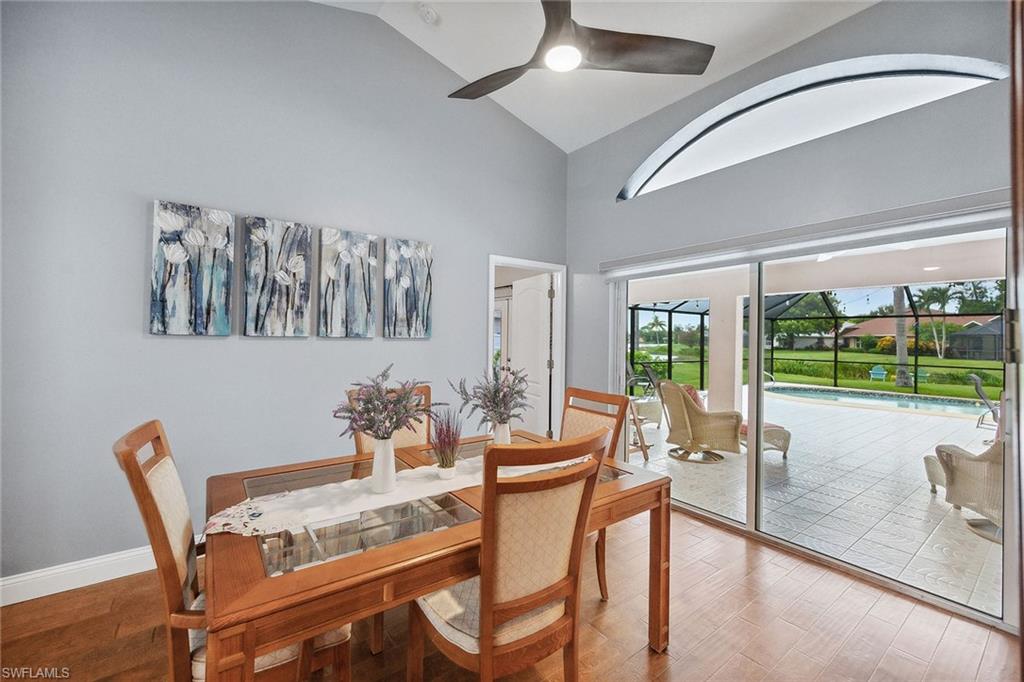 900 Hidden Harbour Drive Naples, FL 34109 - Photo 8 of 32 a dining room with furniture a chandelier and a floor to ceiling window