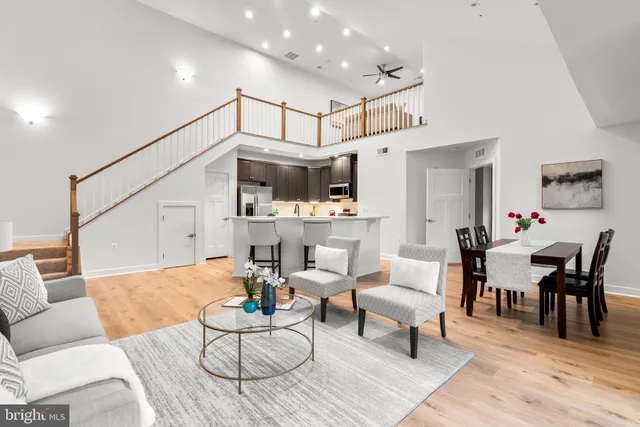 a living room with furniture and kitchen view