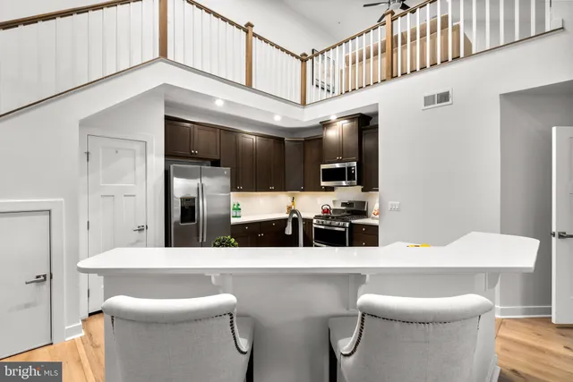 a kitchen with stainless steel appliances kitchen island granite countertop a sink and cabinets
