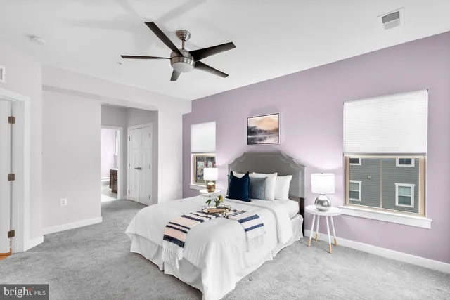 a bedroom with a large bed and a chandelier