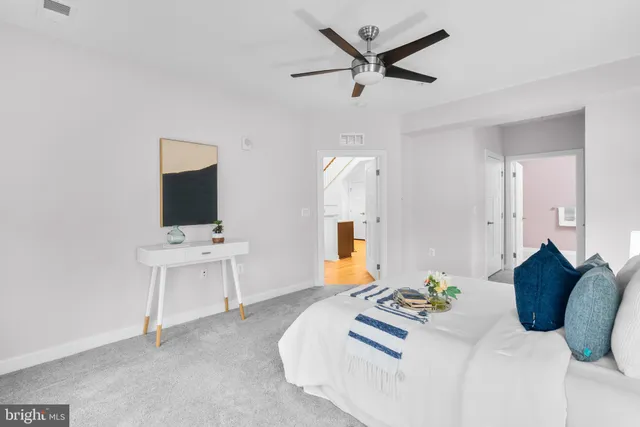 a bedroom with a bed window and a flat screen tv