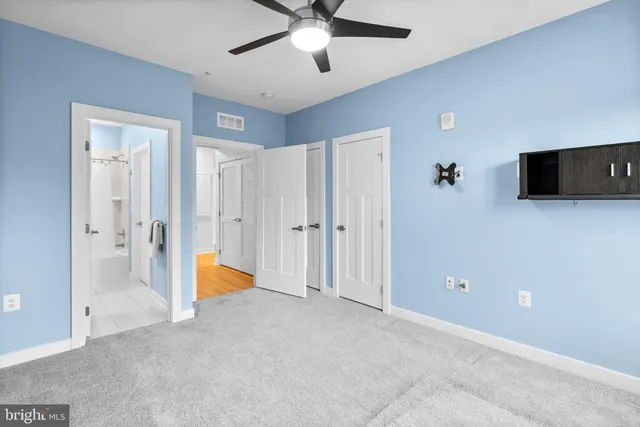 a view of a livingroom with a ceiling fan and entryway