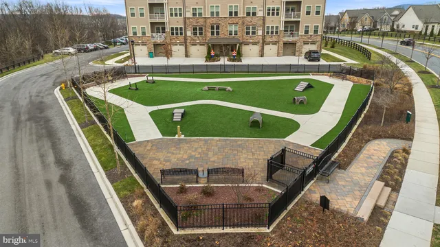 an aerial view of residential houses with outdoor space and parking