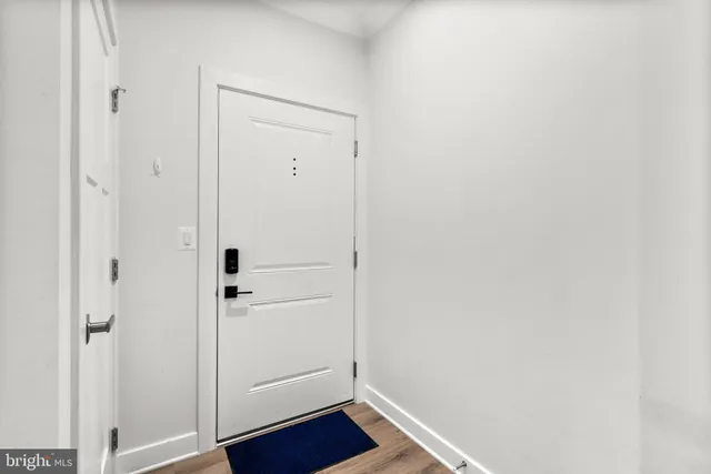 a view of front door with wooden floor
