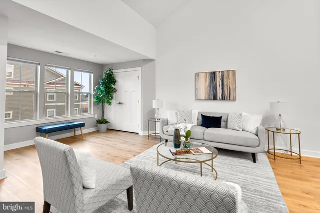 a living room with fireplace furniture and a large window