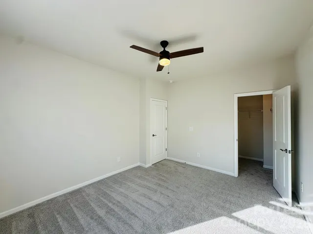 an empty room with a ceiling fan