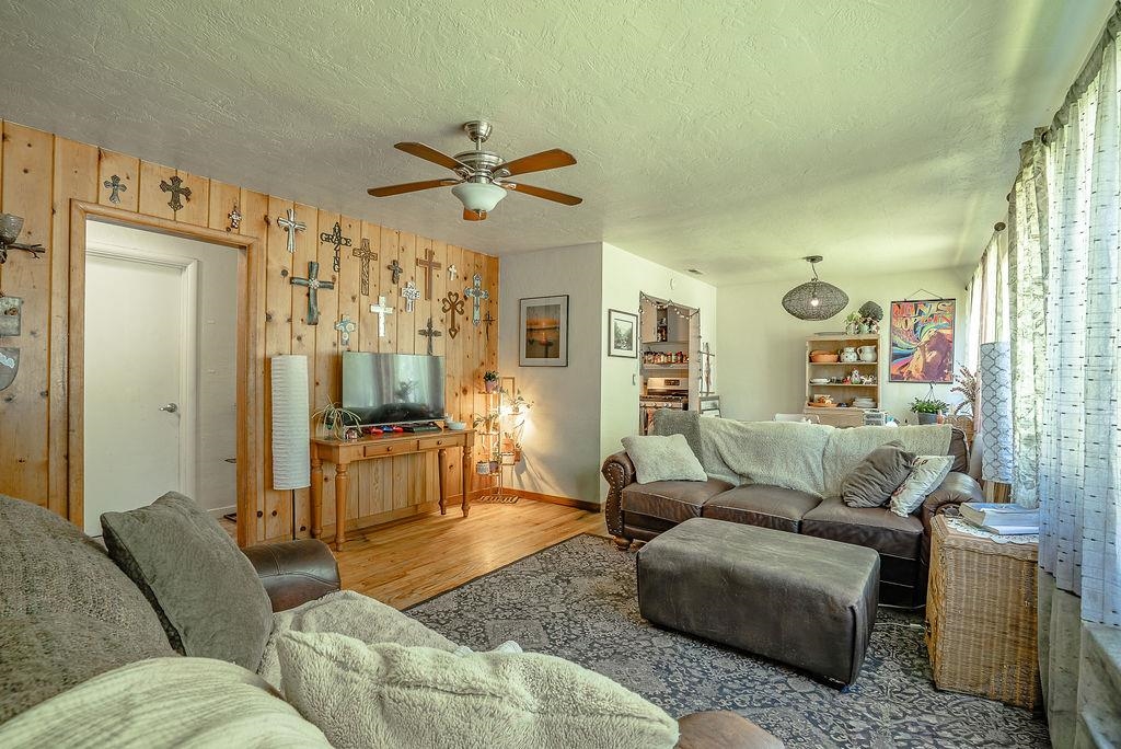 470 Riverside Avenue Chester, CA 96020 - Photo 2 of 25 a living room with furniture and a chandelier