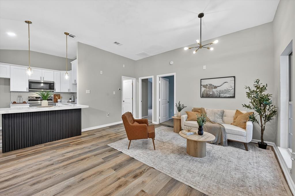 538 Pemberton Hill Road Dallas, TX 75217 - Photo 2 of 31 Open-concept living space featuring wood-finish flooring and light gray walls