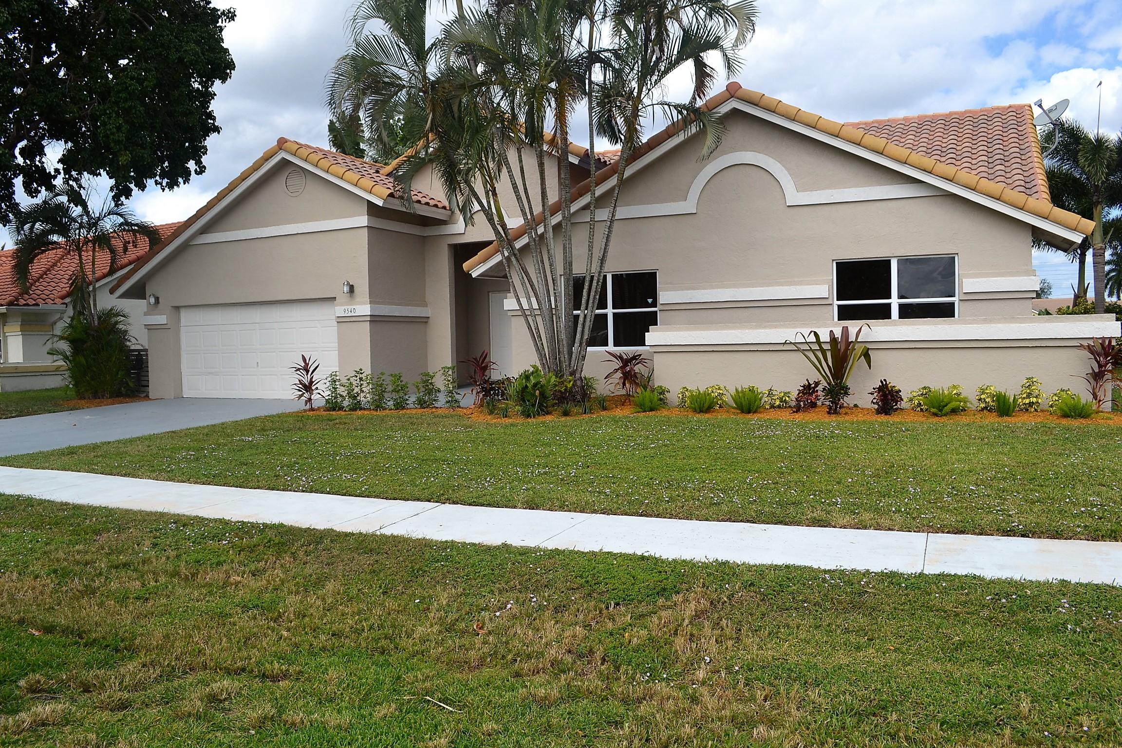 9540 El Clair Ranch Road Boynton Beach, FL 33437 - Photo 1 of 26 a front view of a house with a yard