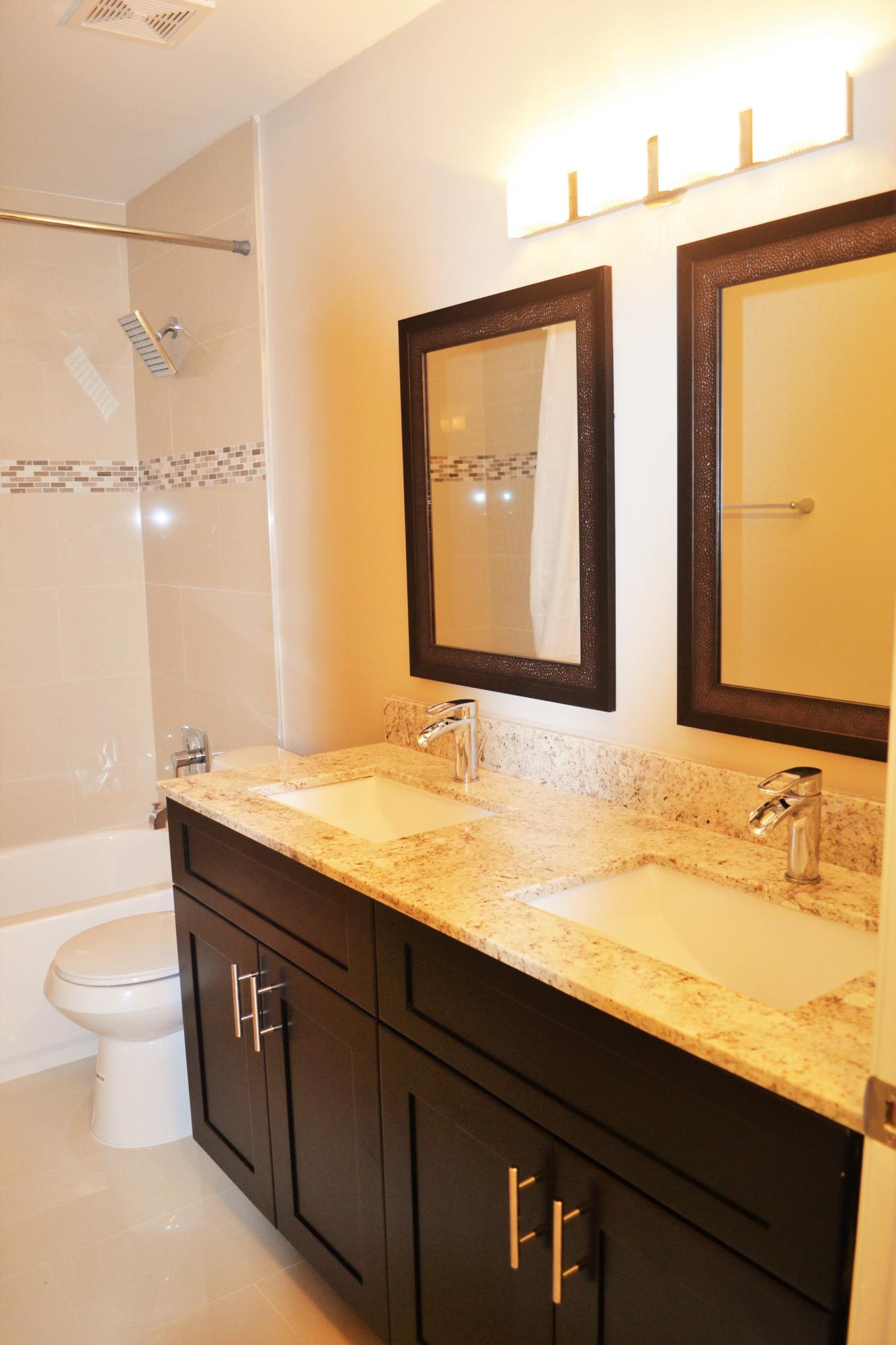 9540 El Clair Ranch Road Boynton Beach, FL 33437 - Photo 12 of 26 a bathroom with a granite countertop sink and a mirror
