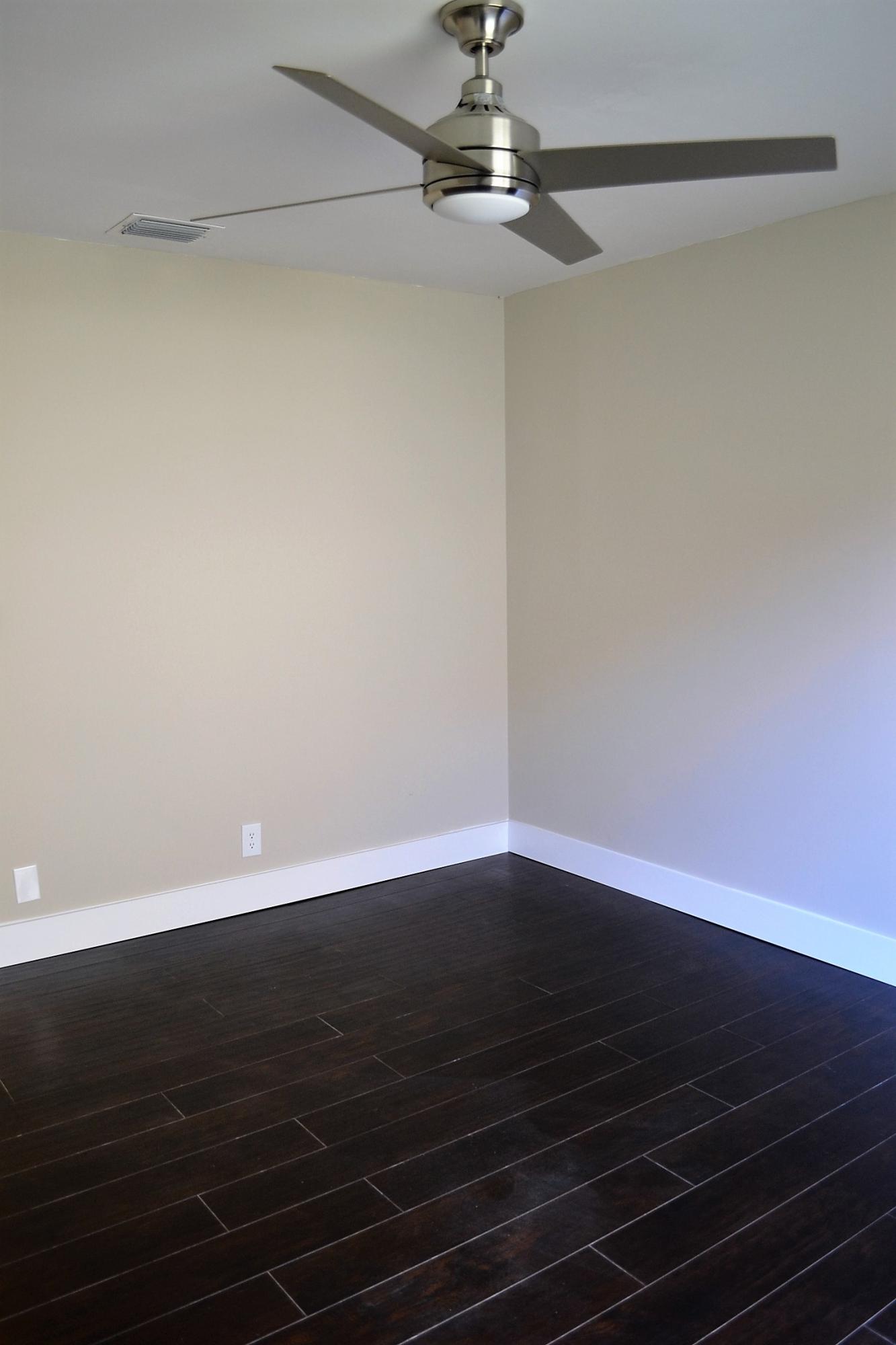 9540 El Clair Ranch Road Boynton Beach, FL 33437 - Photo 14 of 26 a view of an empty room with wooden floor and fan