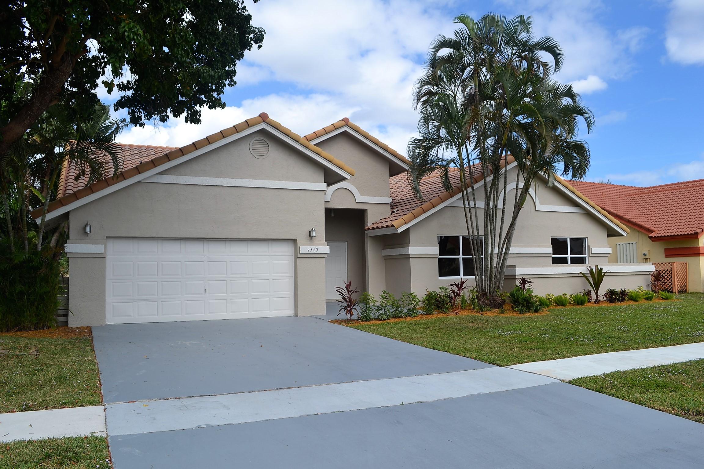 9540 El Clair Ranch Road Boynton Beach, FL 33437 - Photo 2 of 26 a front view of house with yard and green space