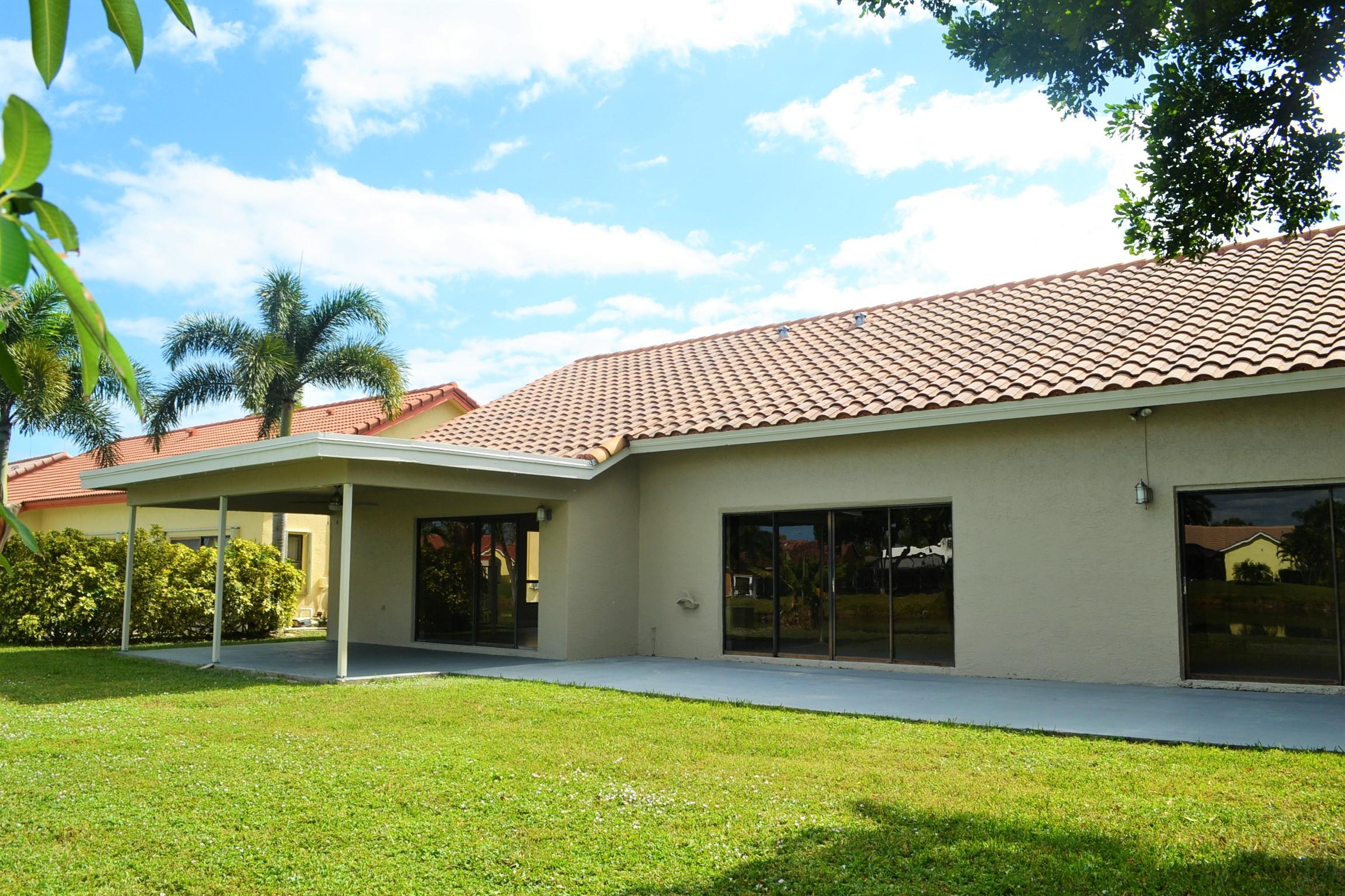9540 El Clair Ranch Road Boynton Beach, FL 33437 - Photo 21 of 26 a view of an house with backyard space and balcony