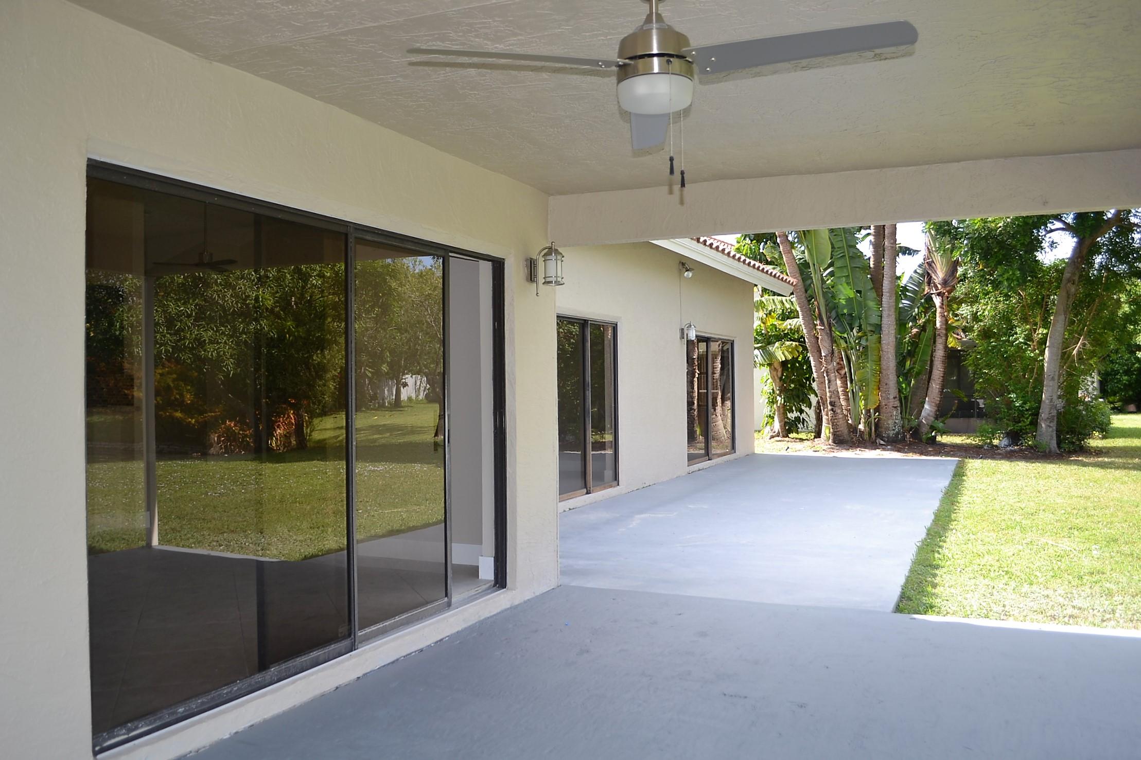 9540 El Clair Ranch Road Boynton Beach, FL 33437 - Photo 25 of 26 a view of a room with a flat screen tv