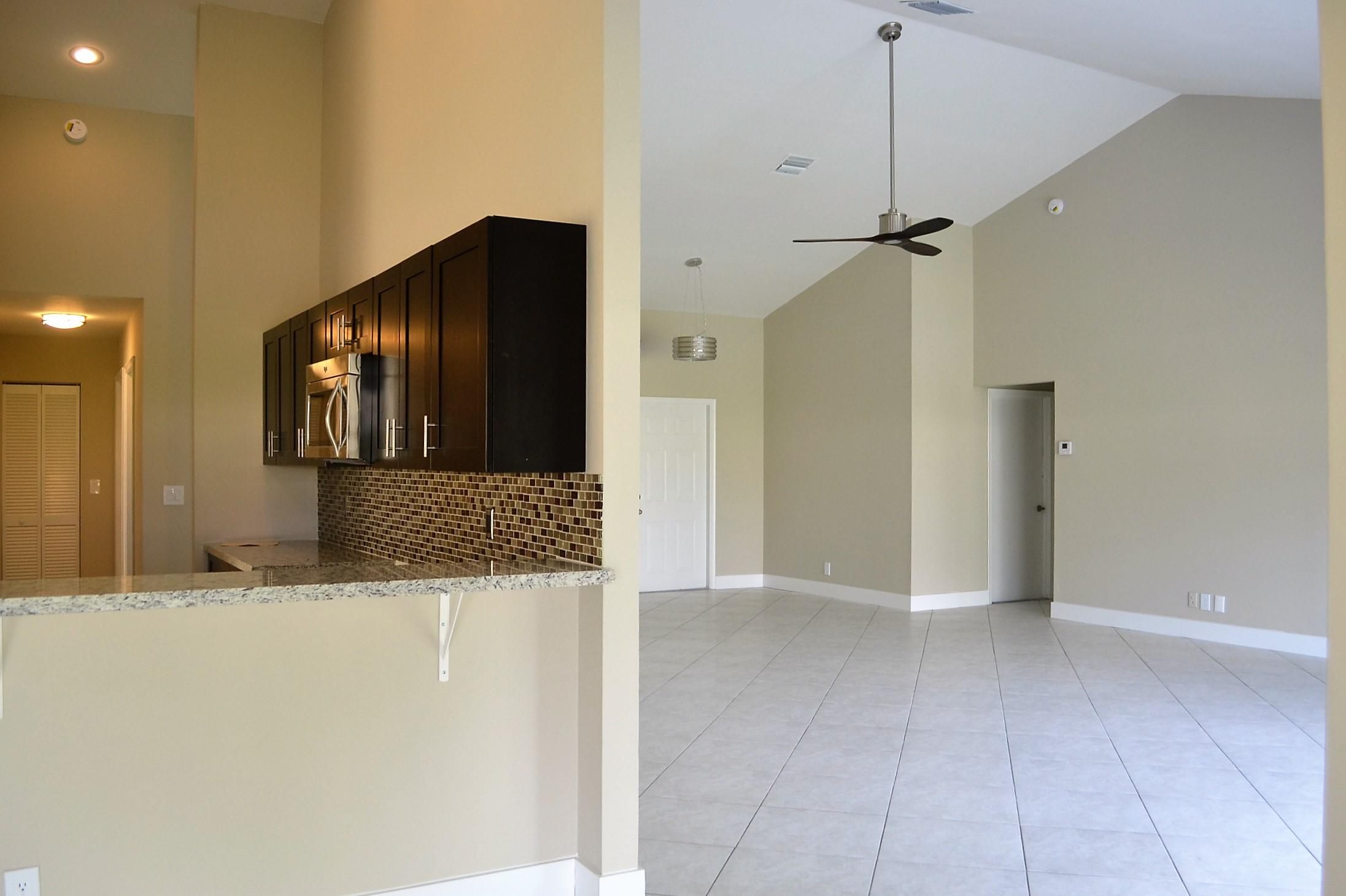 9540 El Clair Ranch Road Boynton Beach, FL 33437 - Photo 5 of 26 a view of a hallway with a kitchen