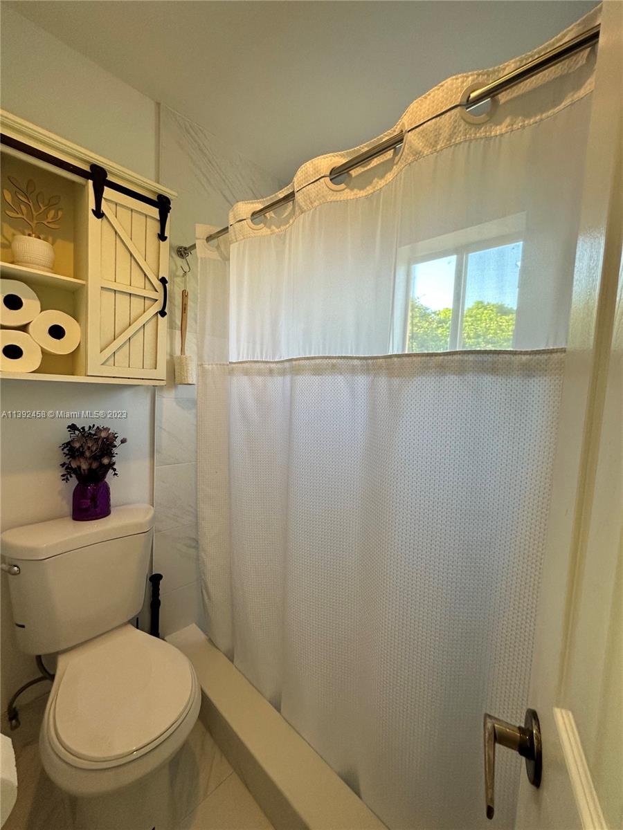 The Ridges Weston, FL 33331 - Photo 11 of 26 a bathroom with a toilet and a shower curtain