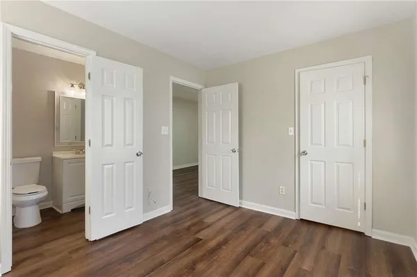 a view of a bathroom with wooden floor and sink