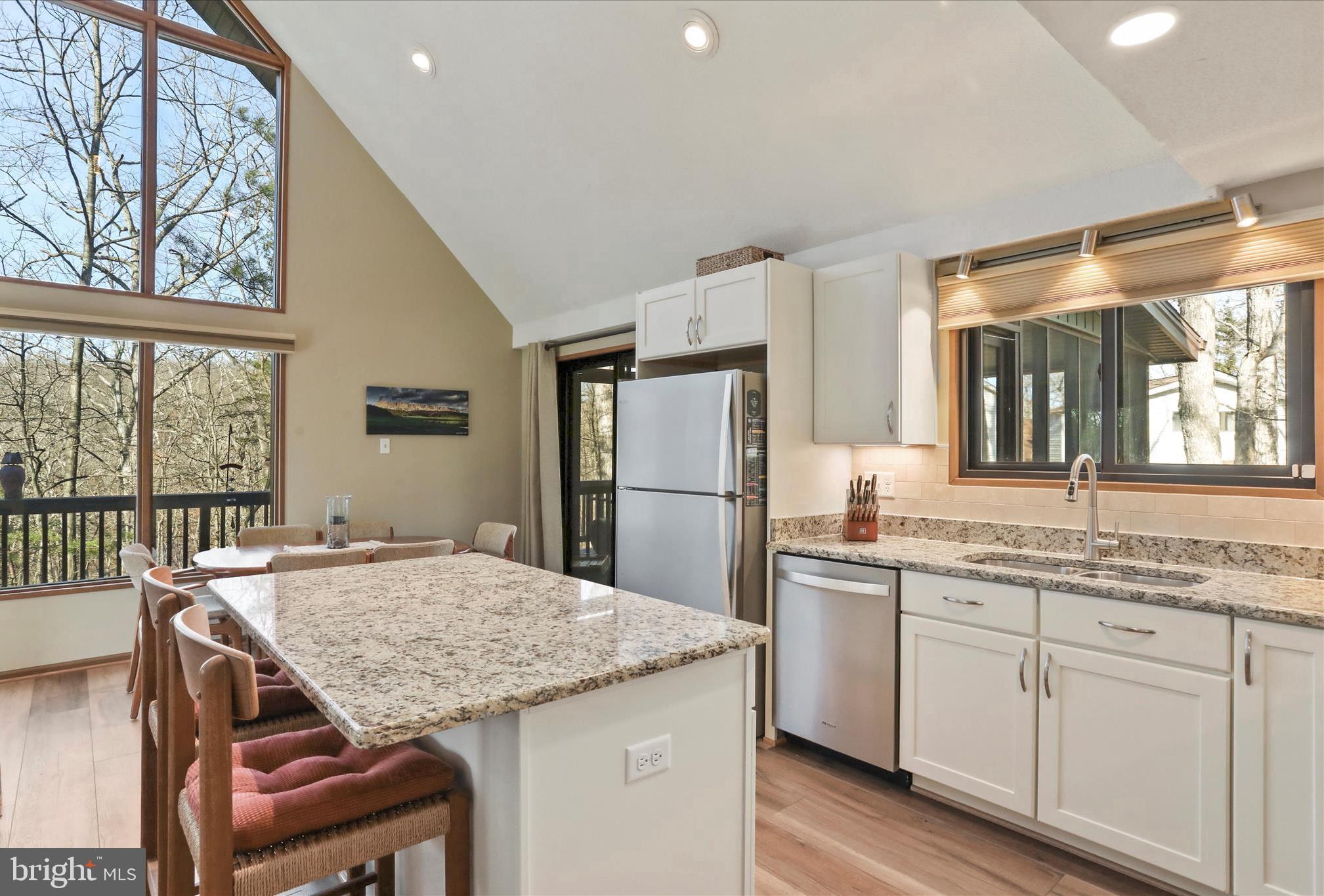 321 Clubhouse Ridge Hedgesville, WV 25427 - Photo 12 of 36 a kitchen with granite countertop kitchen island a stove and a table