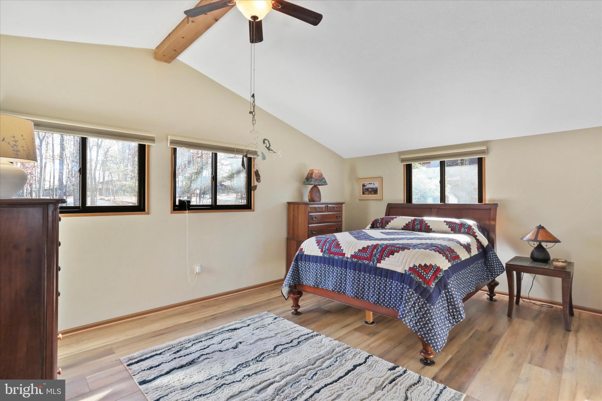321 Clubhouse Ridge Hedgesville, WV 25427 - Photo 20 of 36 a bedroom with a large bed wooden floor and window