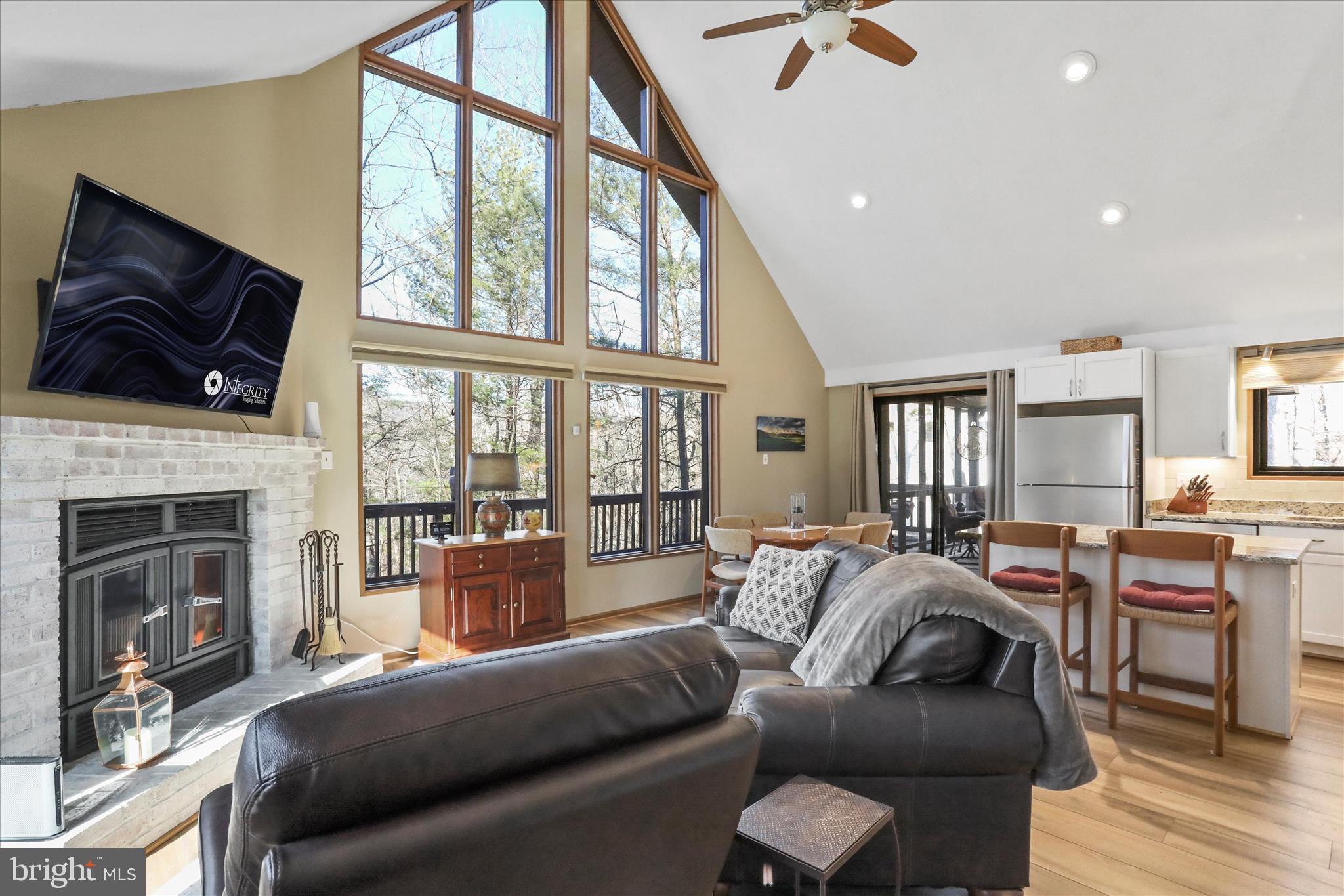 321 Clubhouse Ridge Hedgesville, WV 25427 - Photo 6 of 36 a living room with furniture a fireplace and a flat screen tv
