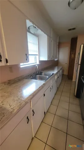 a kitchen with a sink and cabinets