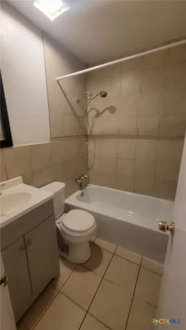 a bathroom with a toilet a sink and bathtub