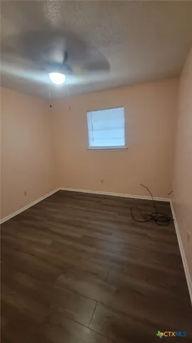 a view of a room with wooden floor