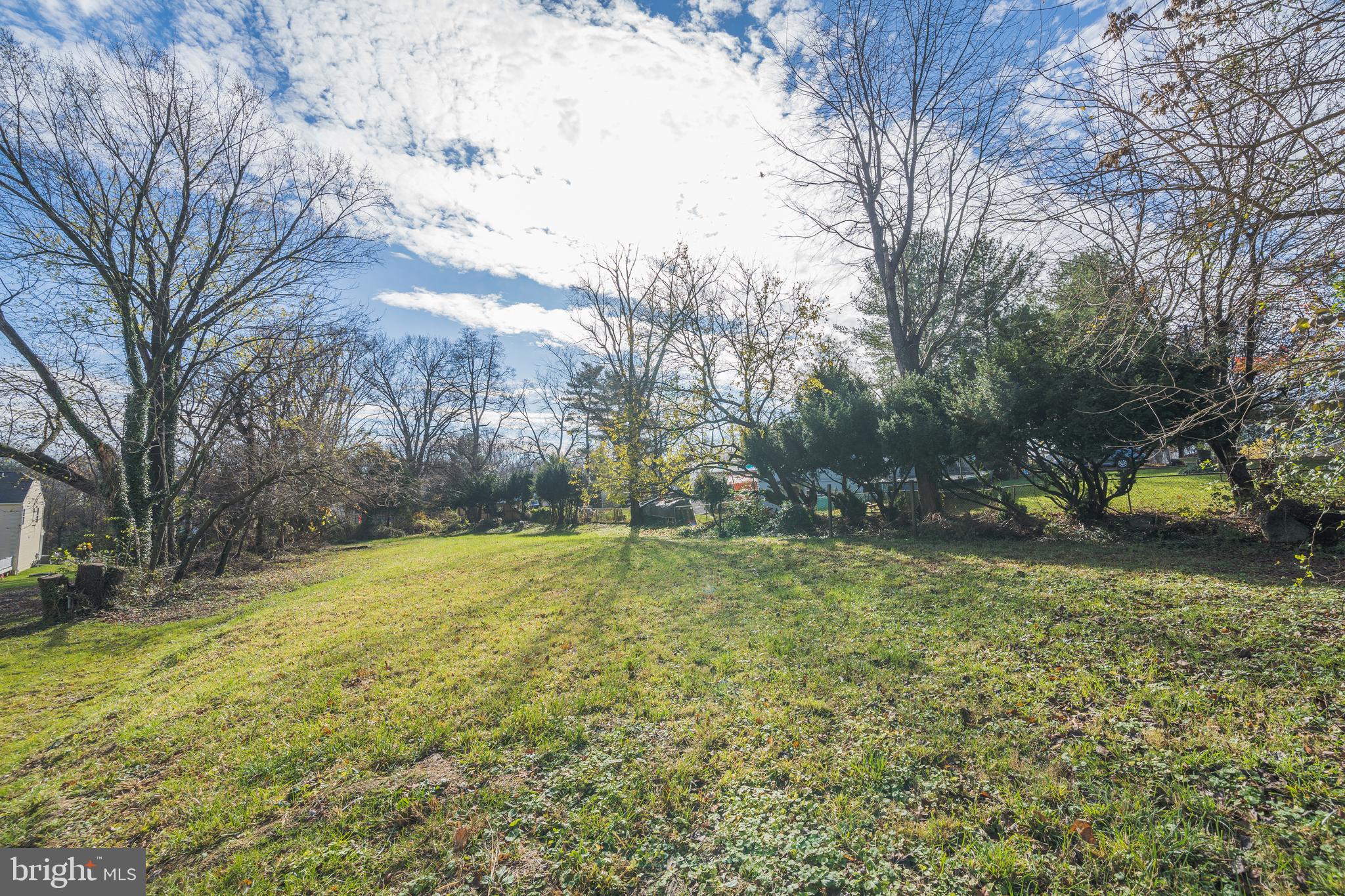 18529 Strawberry Knoll Road Gaithersburg, MD 20879 - Photo 1 of 12 a view of a yard with trees