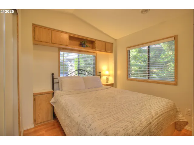 a bedroom with a bed and a large window